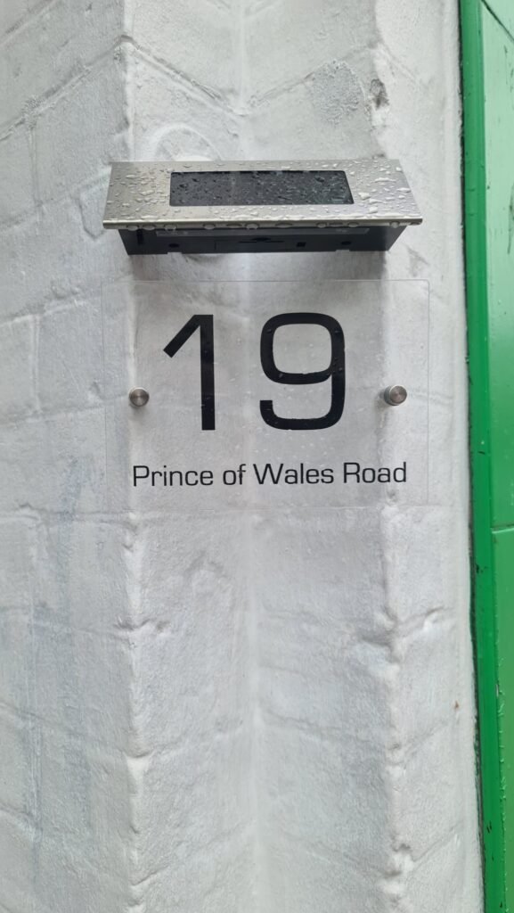 front door sign displaying the number 19 and Prince Of Wales Road